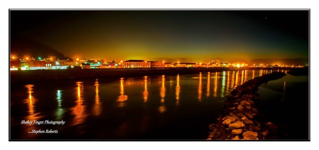Evening lights on Grey River with Greymouth township lights